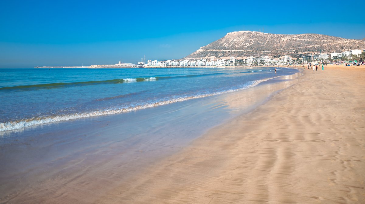 Agadir beach on the Atlantic African coast in the summertime with yellow sand and turquoise water in Morocco
